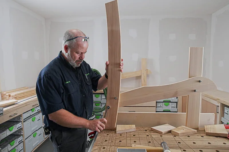 Brent securing back of the chair