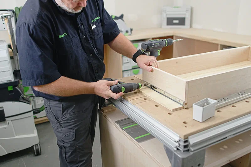 Brent attaching the slider to the drawer