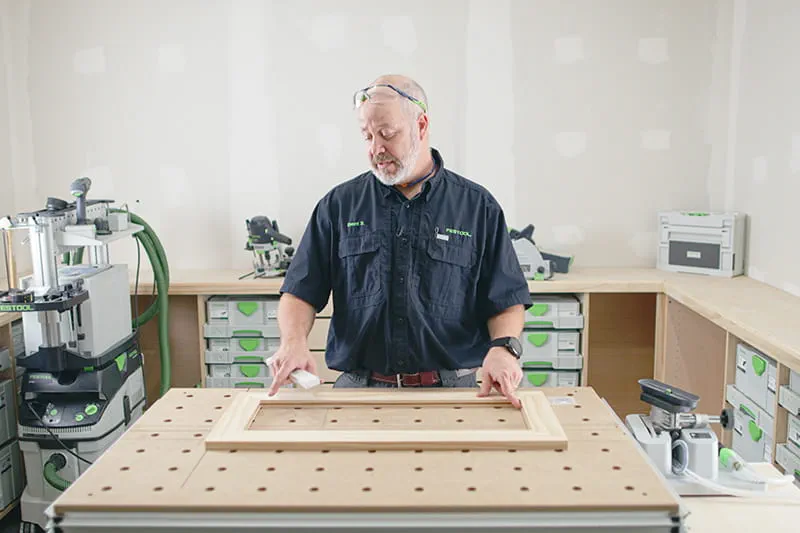 Brent planning out the front of the cabinet door