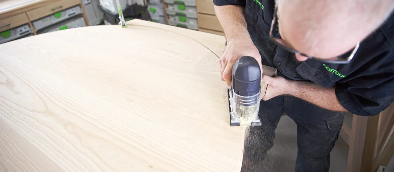 Brent using a router to cut out the table top