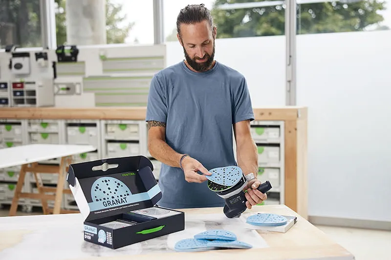 Tradesperson changing the sander abrasive