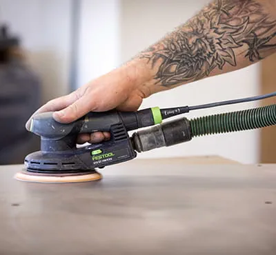 Tradesperson using a sander